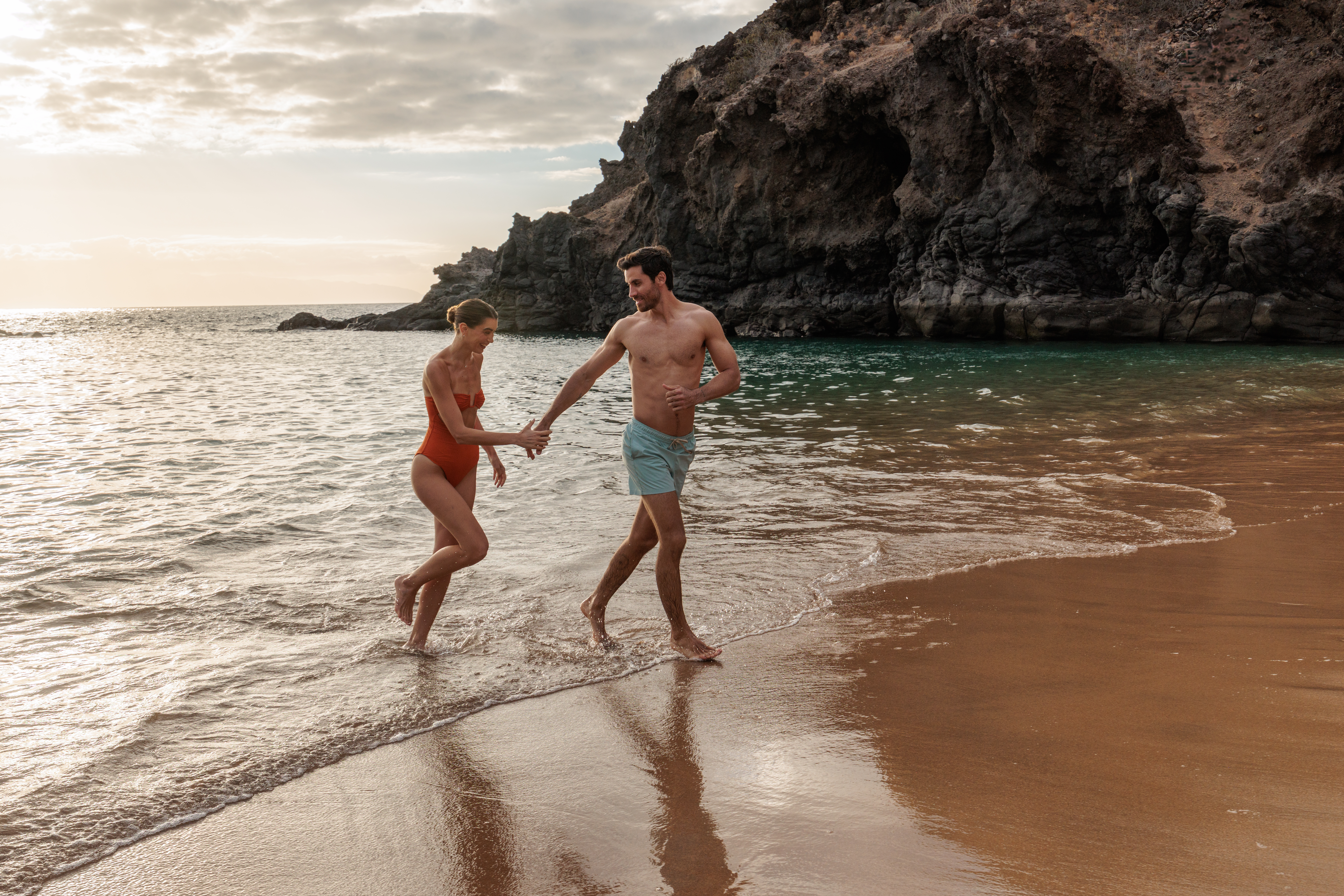 Couple walking along Abama Beach